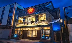 Distillery Water Dragon Building at Night